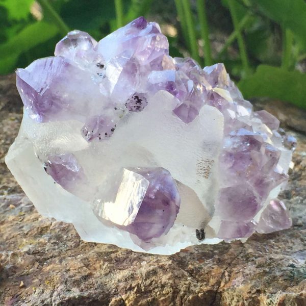 geometric white calcite covered with masses of amethyst points, naturally formed