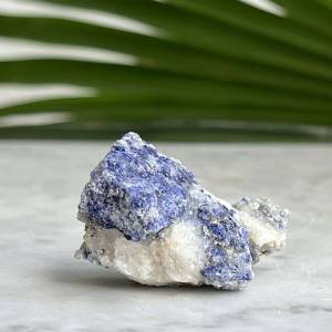 natural lapis lazuli in a white calcite bedrock