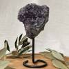 amethyst cluster on black metal stand