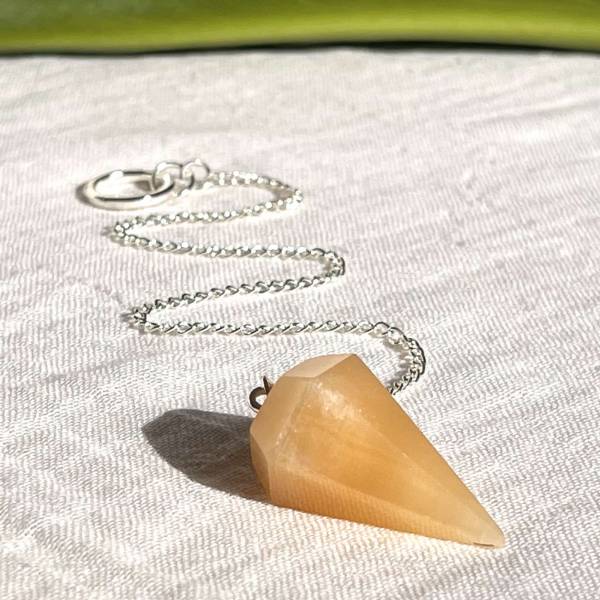 Orange calcite pendulum
