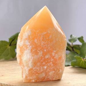 Orange calcite - part polished with six sided tip and natural bottom half