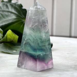 Fluorite obelisk with some chevron bands of clear, green and purple fluorite