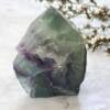 part polished green and purple fluorite six sided point, natural base