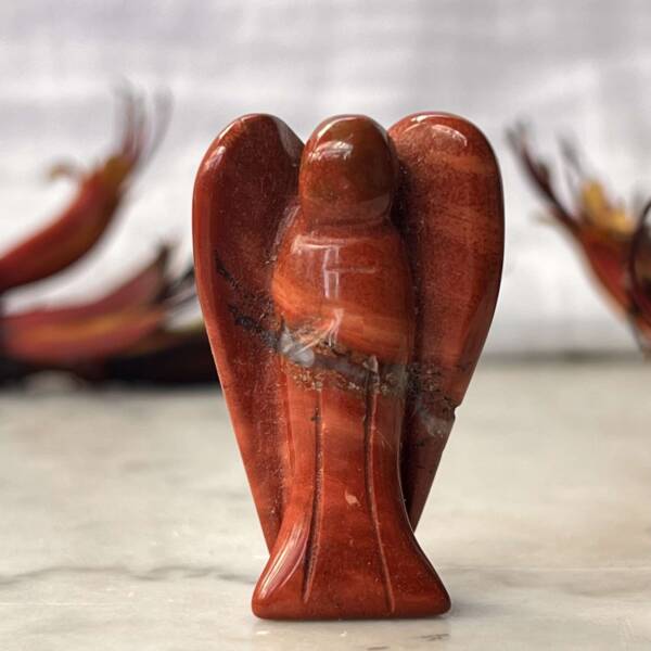 a carved red jasper angel