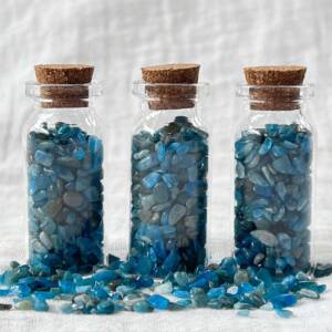 apatite polished chips in a glass bottle
