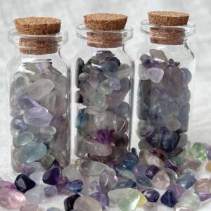 fluorite polished chips in a glass bottle