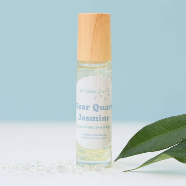 clear quartz and jasmine positive affirmation oil, glass bottle, crystal roller ball, full of small polished clear quartz, essential oil and sweet almond oil