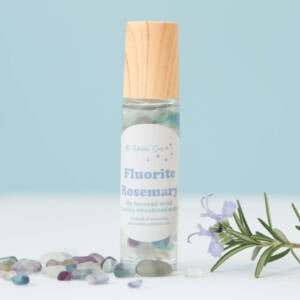 fluorite and rosemary positive affirmation oil, glass bottle, crystal roller ball, full of small polished fluorite, essential oil and sweet almond oil