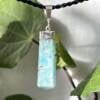 bright aqua caribbean calcite pendant set in silver six sided with three point tip