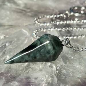 emerald pendulum six sided with a white metal chain and ring