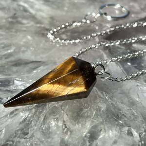 golden tiger eye pendulum with a white metal chain