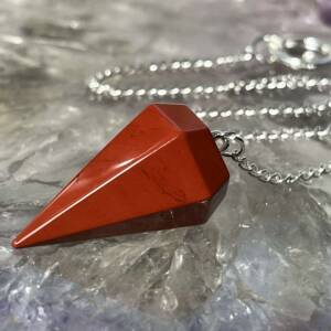red jasper pendulum with six sides and a white metal chain with ring