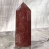 strawberry quartz tower with six sides and faceted point