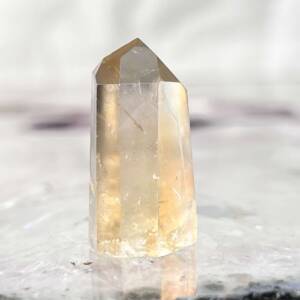 natural citrine tower with a golden hue to the quartz, six sides and six facets to form the point
