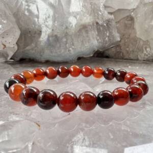 natural carnelian bracelet made with 8 mm beads on a red elastic