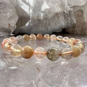 golden rutile included quartz bracelet with some black tourmaline beads all 8 mm diameter on orange elastic