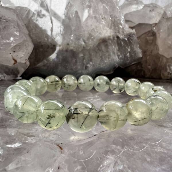 prehnite bracelet made with 10 mm beads and threaded on a green elastic