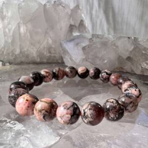 rhodonite bracelet made with 10 mm crystal beads on a pink elastic