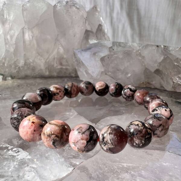 rhodonite bracelet made with 10 mm crystal beads on a pink elastic