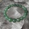 green aventurine bracelet made with 10 mm round beads on white elastic