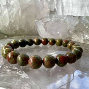 unakite bracelet made with pink and green mineral beads on white elastic