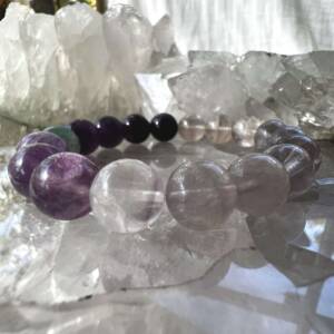 fluorite bracelet made with 12 mm spherical beads of lilac, purple and green natural fluorite colour