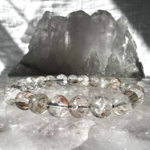 rutilated quartz bracelet made with clear crystal 7 mm round beads with rutile inclusions