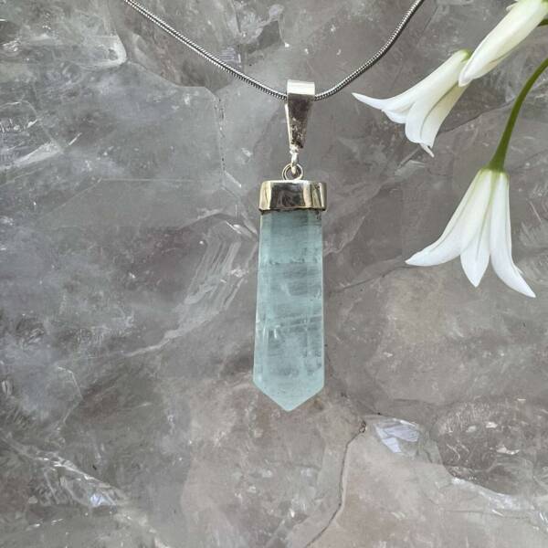 aquamarine pendant pale blue facet cut and polished semi precious stone set in silver