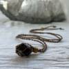 brown macrame gem cage necklace with wooden bead