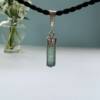 green tourmaline pendant set in silver natural three sided crystal shape