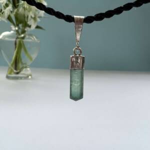 green tourmaline pendant set in silver natural three sided crystal shape