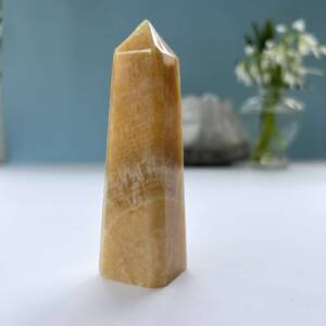 orange calcite obelisk four sides with a pyramid top