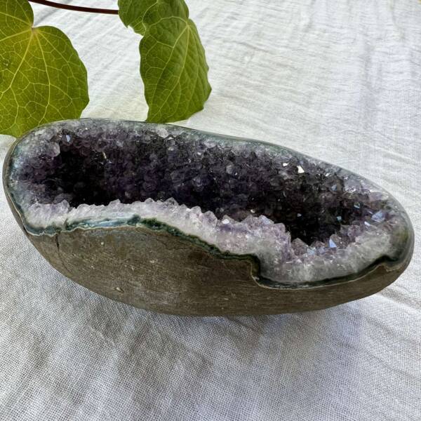 half geode amethyst cluster partly polished smooth agate bedrock silicon dioxide with manganese